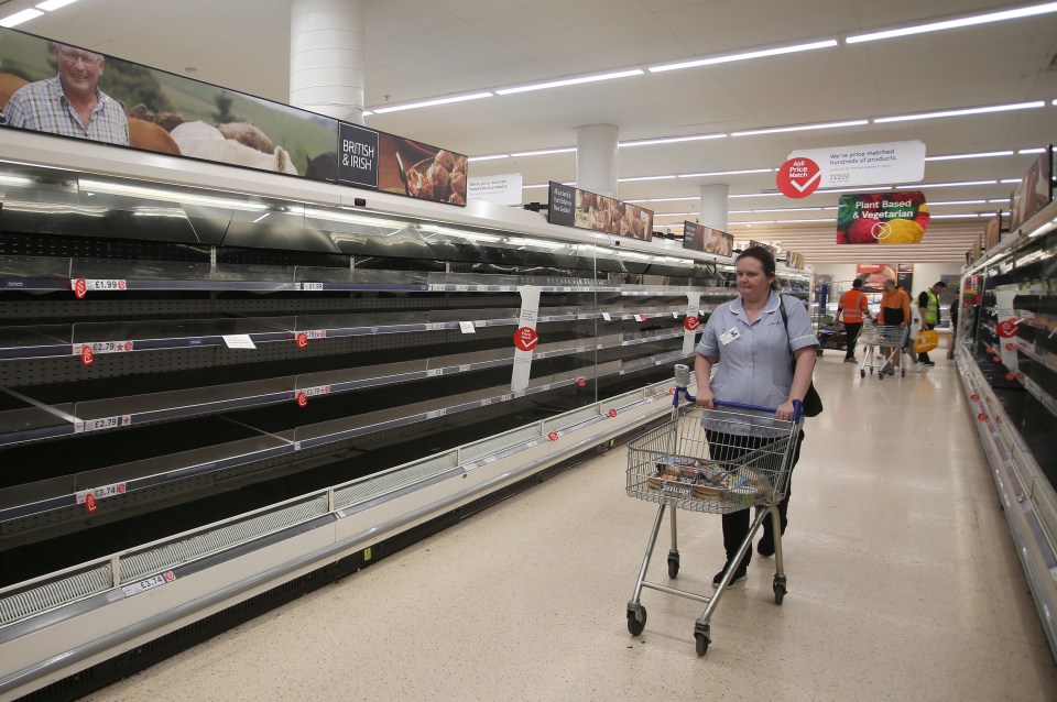  A NHS nurse stands in front of empty shelves in Gillingham, Kent