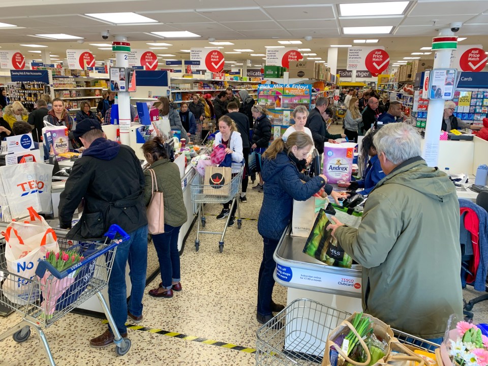  Shoppers in Tesco, in Cambridge, greedily snap up their essentials this morning