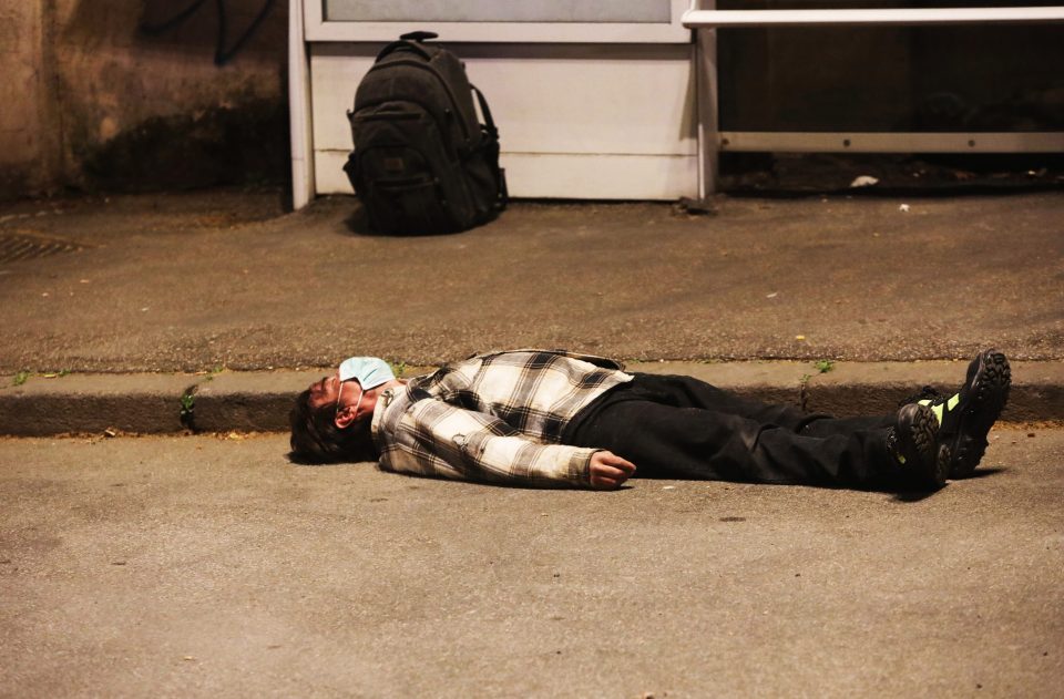  Chilling pictures show the moment a man wearing a face mask was found collapsed on the street in Italy