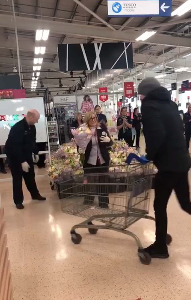  NHS workers being greeted with applause and flowers by Tesco staff in Belfast