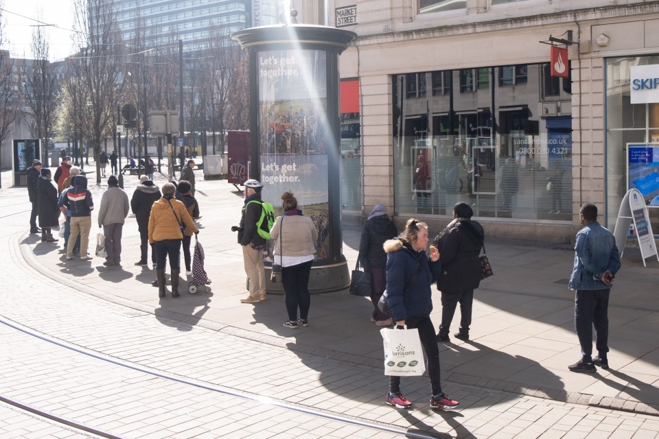  The queues outside a branch of Santander in Manchester stretched to around the corner