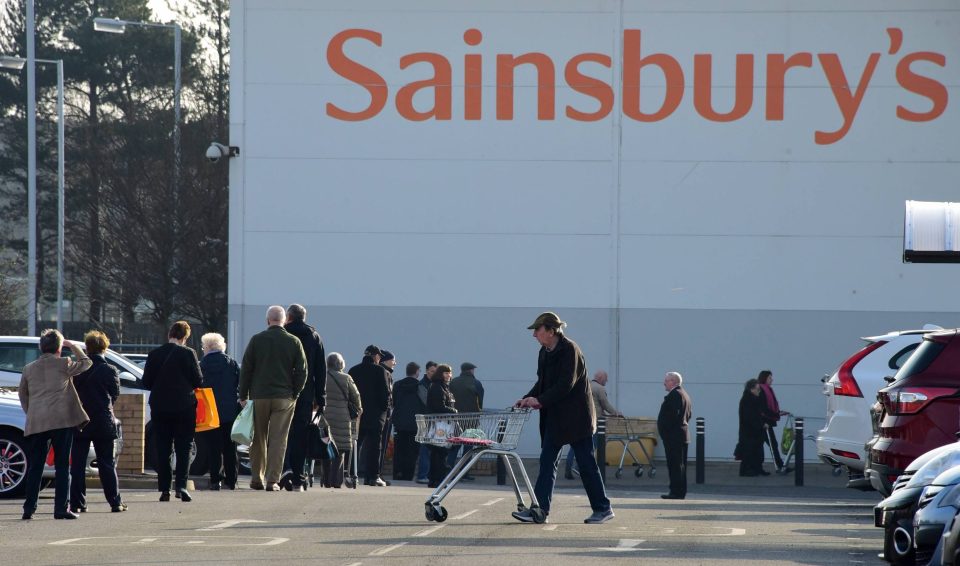 Early morning shoppers queue outside waiting for the Sainsbury's supermarket to open in Heaton, Newcastle upon Tyne,