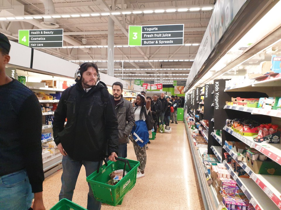  Shoppers queue inside a busy Asda