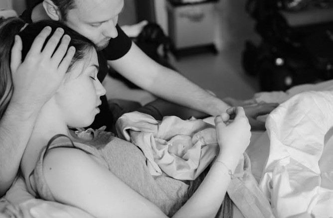  Emma, pictured in her grieving parents' arms, suffered from a rare brain anomaly