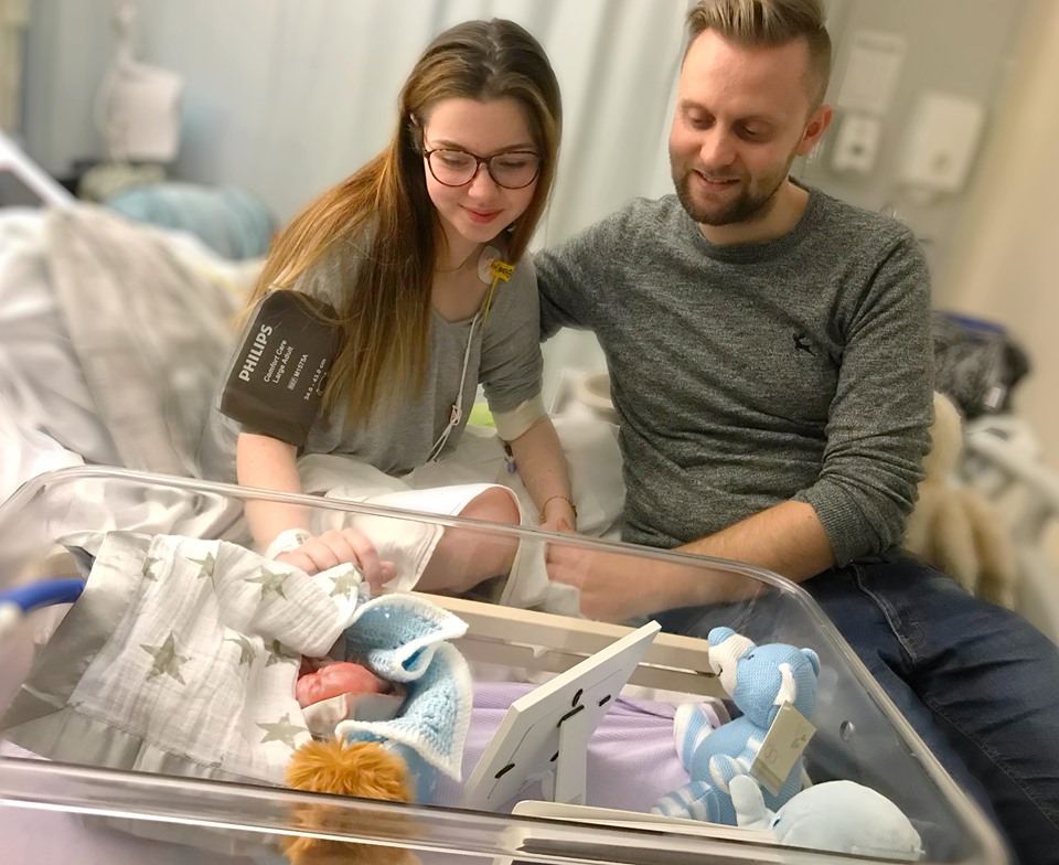  Chloe and Jordan smile down at Samuel, who also suffered from a brain anomaly