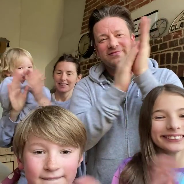 Jamie and Jools Oliver clap with their family