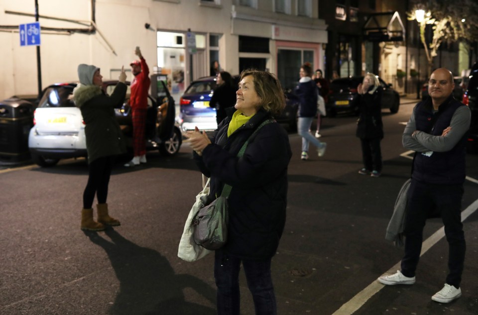 Dr Olivera Potparic Anestesis applauds her colleagues after finishing a 12 hour shift at Chelsea and Westminster Hospital