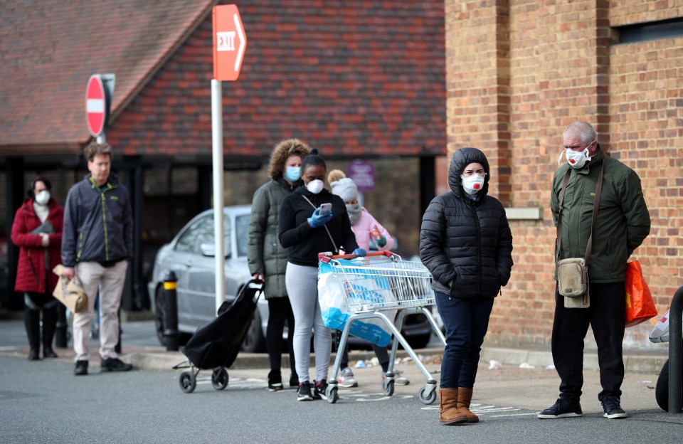  Shoppers also wear face masks as they queue