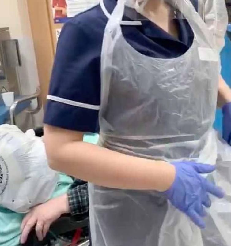  One nurse wearing poor protection equipment that doesn't cover up the body