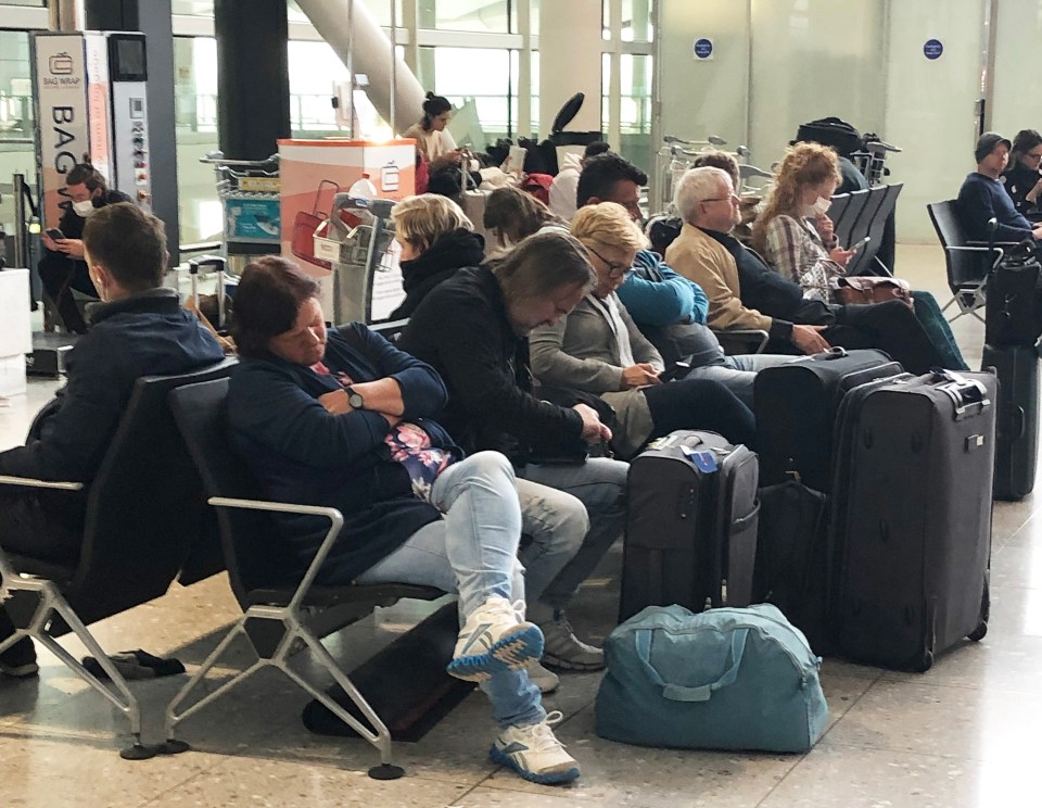  Despite the Government's guidelines, passengers at Heathrow airport on Monday ignored social distancing rules