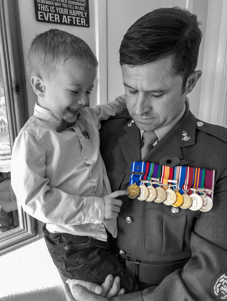  A soldier with his son checking his medals in Ambrosden, Oxfordshire, which as houses British Army personnel stationed at St. George's Barracks