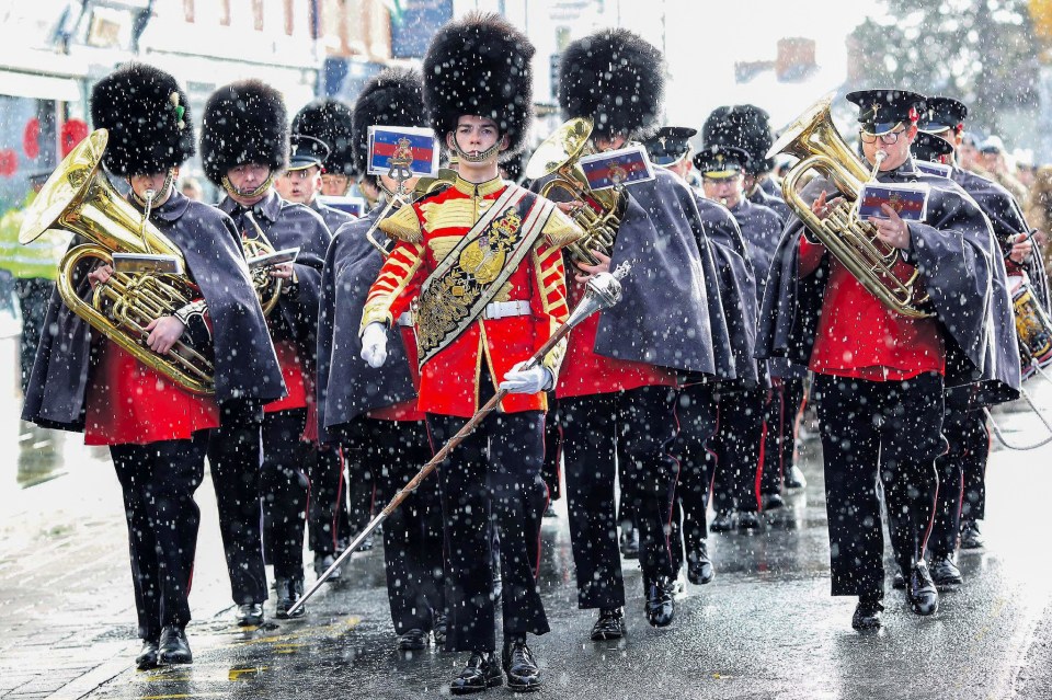  A picture called "Play On" shows the Grenadier Guards marching in the rain in London