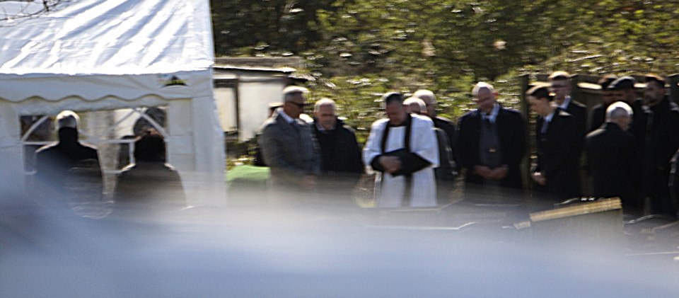  A vicar could be seen talking to family members