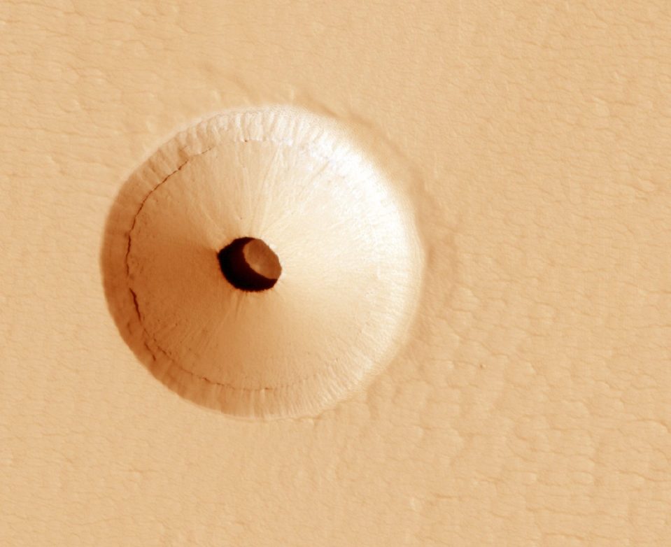 This image snapped by the Mars Reconnaissance Orbiter shows a mysterious hole on Mars