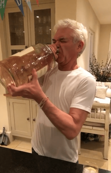  Phillip Schofield became the envy of gin lovers everywhere last night after taking a swig from a HUGE bottle during a boozy night in