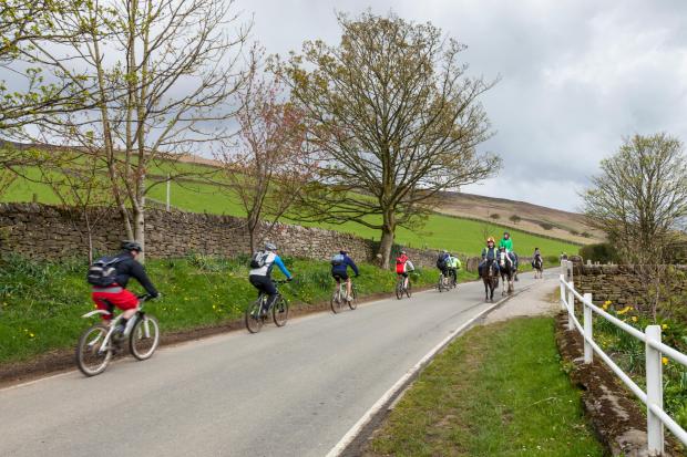 Cycling and horse riding in the Peak District. Nether Booth, Vale of Edale, Derbyshire, England, UK