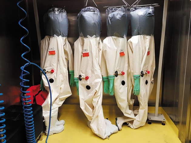 Hazmat suits hang ready for use as the Institute of Virology in Wuhan