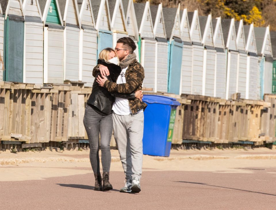  A couple enjoy a walk along Bournemouth beach