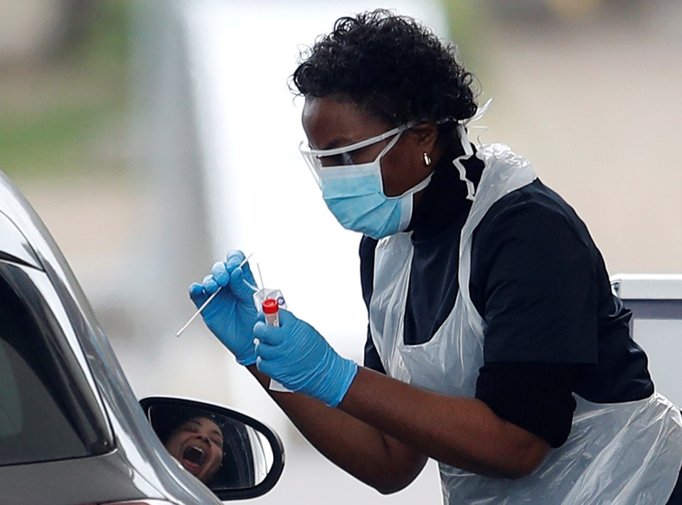  Medical staff at an NHS drive through coronavirus testing facility in Chessington