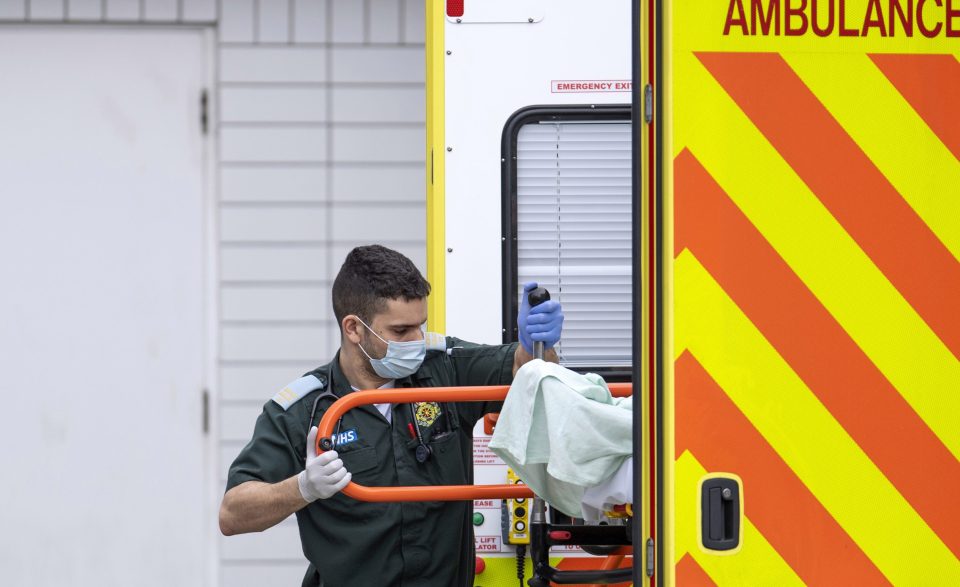  A medic wearing a mask in the midst of the coronavirus pandemic gripping the UK