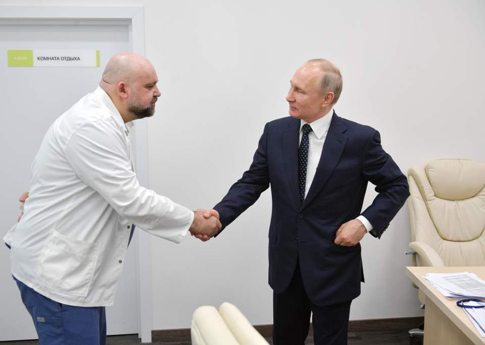  Vladimir Putin shaking hands with the head of Moscow's main coronavirus hospital Denis Protsenko on March 24