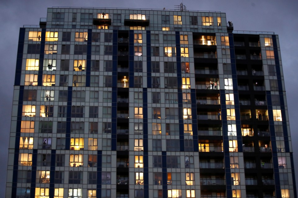  Dozens of people stood at their windows and on their balconies this evening