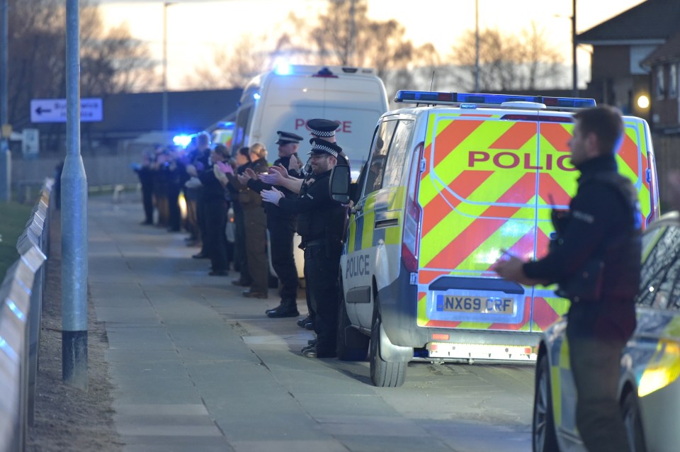  Police officers paused for a moment and joined the clap