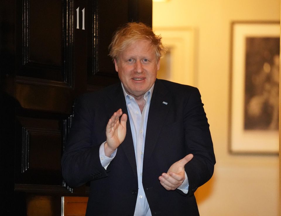  Prime Minister Boris Johnson clapping outside 11 Downing Street in London to salute local heroes during Thursday's nationwide Clap for Carers