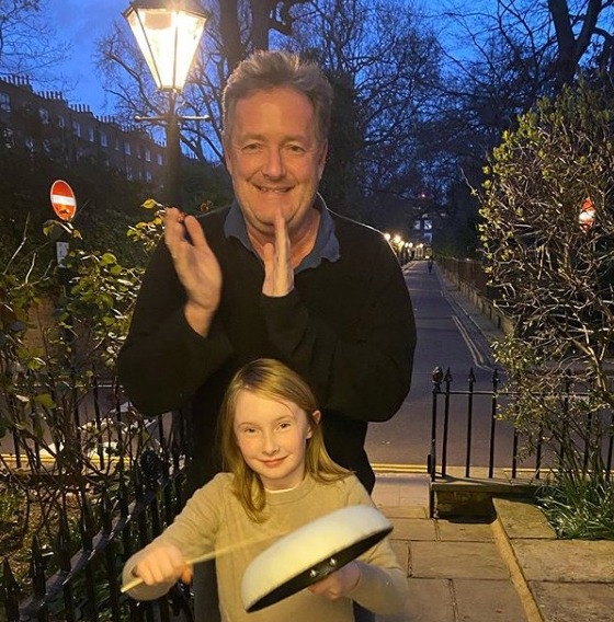  Piers Morgan claps while his daughter hits a pan to make some noise for the NHS