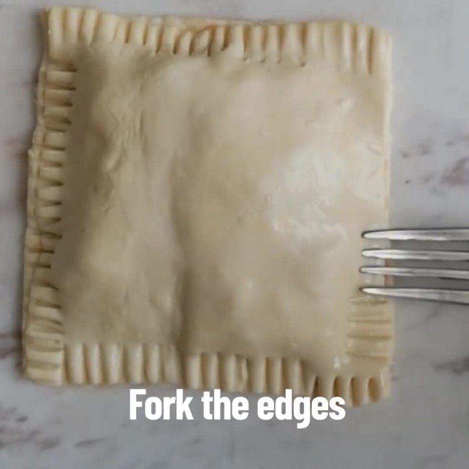 Add an identical square of puff pastry on top and use a fork to seal the edges