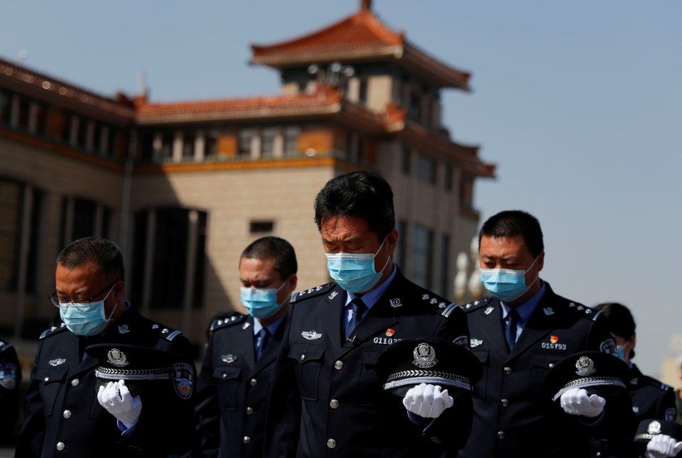  Security personnel wearing face masks pay tribute as China holds national mourning for those who died of coronavirus on April 4