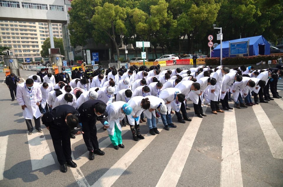  Medical workers pay a silent tribute to comrades lost to coronavirus in Wuhan on April 4