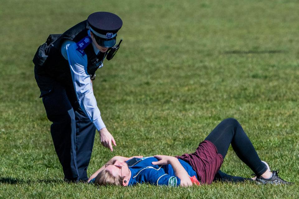  Police telling people having a sunbathe to go home