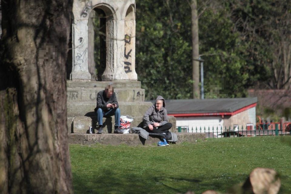  Two men sit closely together in Hull in the sunshine