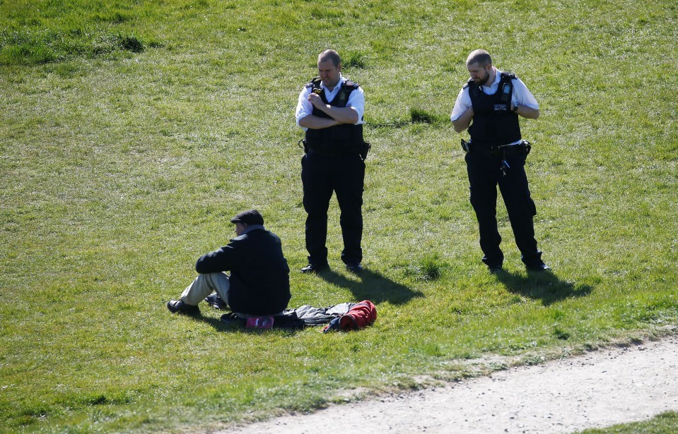  Police speak with a man in Norholt as he enjoys the sunshine