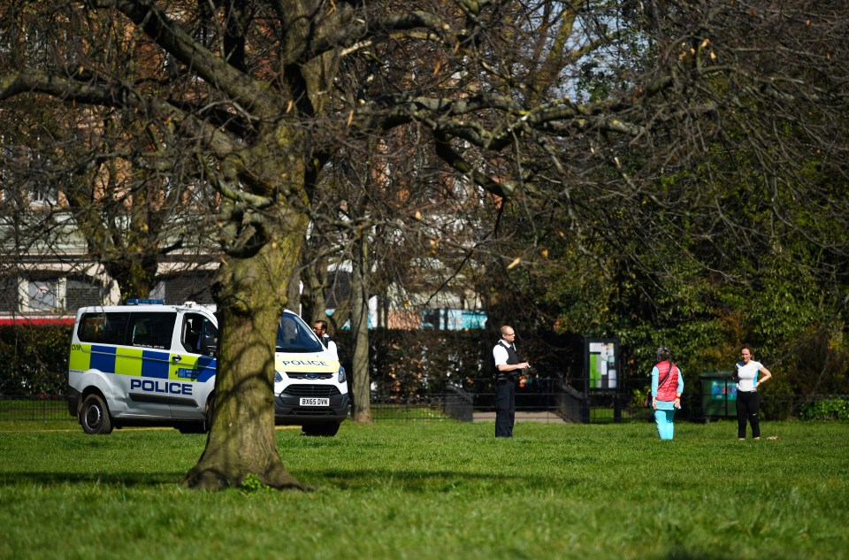  Police speak with two people in Kensington Gardens after the government told people to stay home this weekend