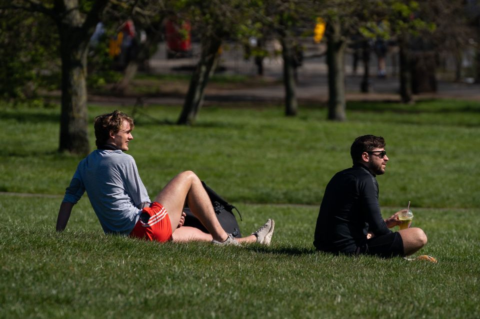  Two people in London sun bathe amid the government's warning of a total of outdoor exercise