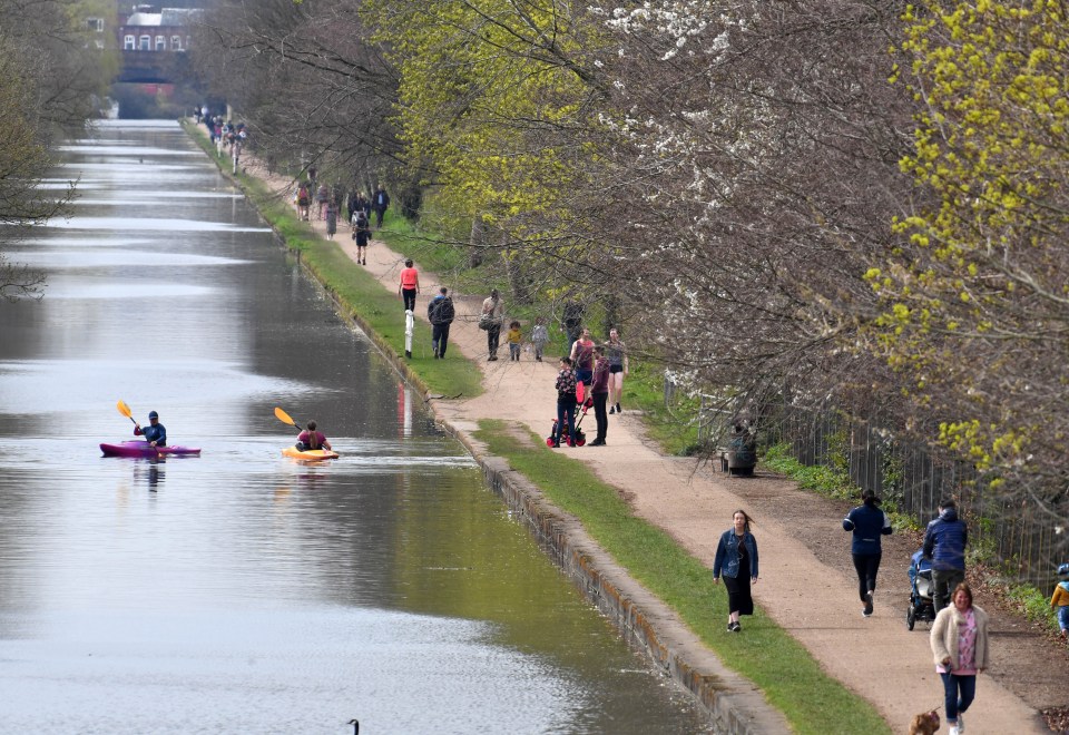 Walkers crowd along a Manchester canal