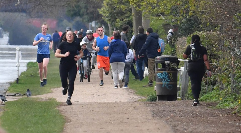  Dozens of people were seen exercising along a busy canal in Manchester on Sunday morning, making to difficult to follow the government's social distancing guidelines