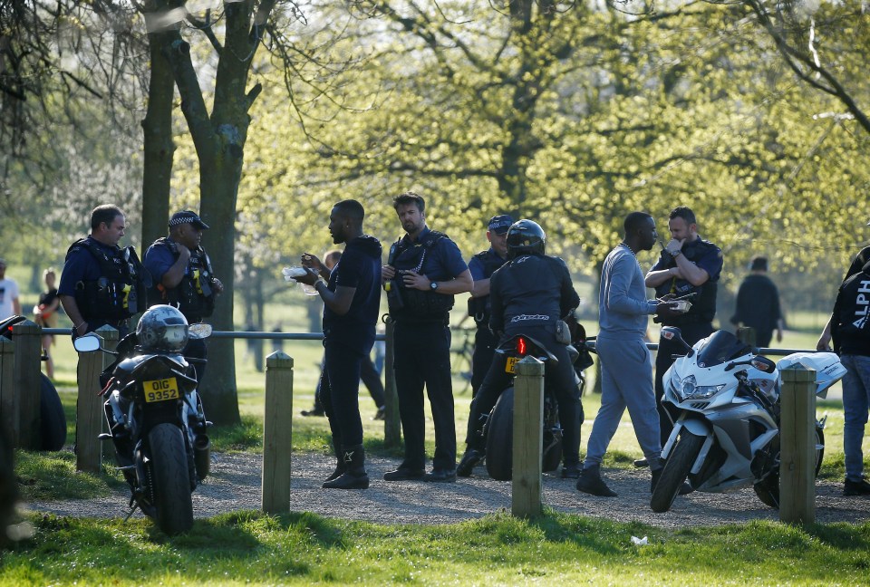 Police try to disperse a crowd of people gathered in Clapham Common, South London, on Sunday