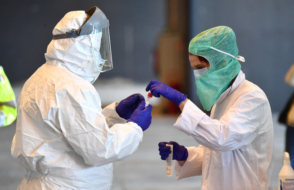  Health workers collect swabs and conduct tests on motorists in Genoa