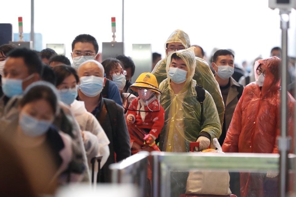  Queues of people at the train station waiting to leave the city