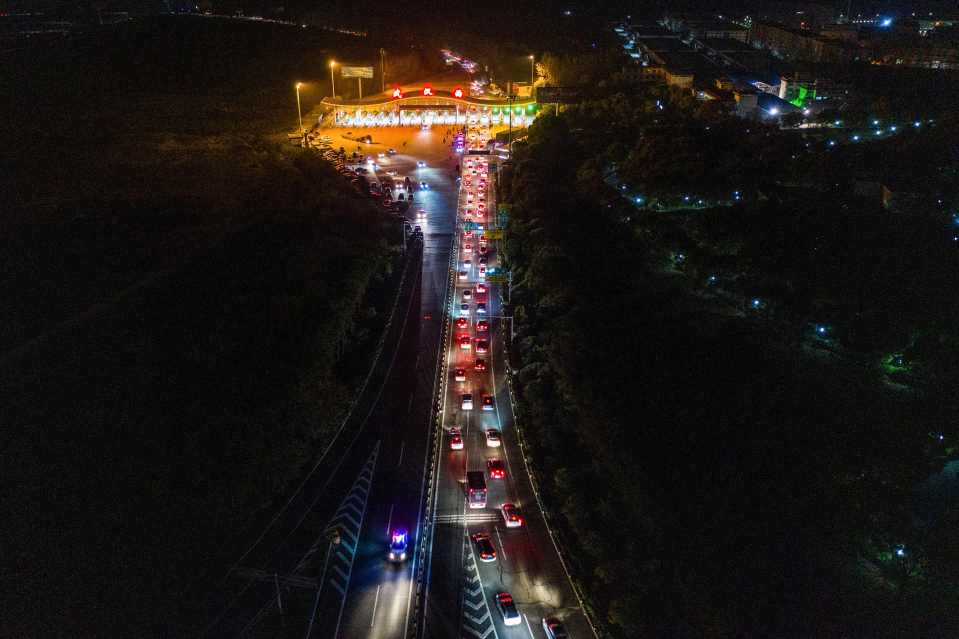  A long line of cars began building up to leave the city as the lockdown was lifted on April 7