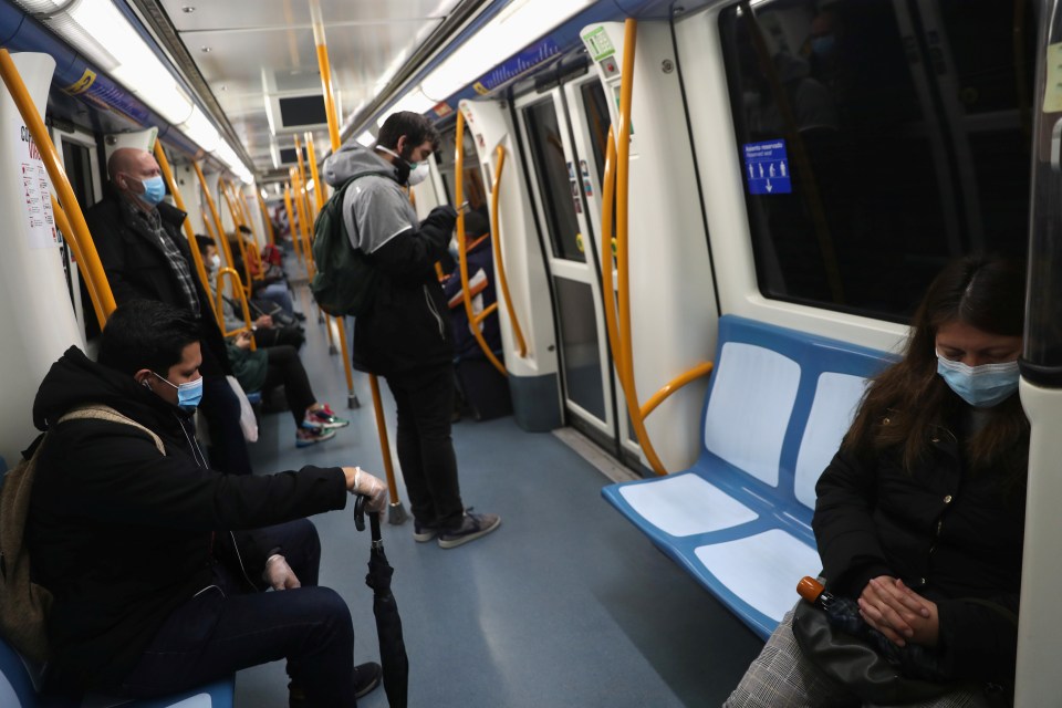  Madrid subway passengers attempt to maintain social distancing as they head back to their jobs