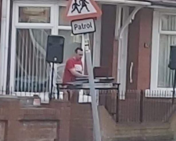  DJ Chris, who organised the event, plays music at the street party