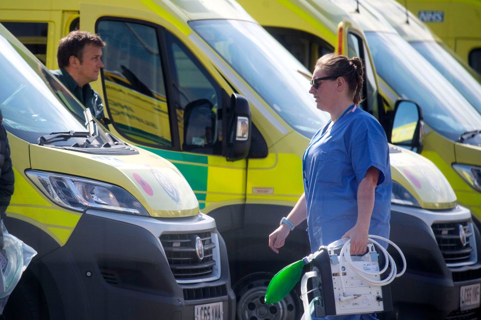  NHS workers prepare a line of ambulances outside at the NHS Nightingale Hospital at the ExCel Centre in London on April 14