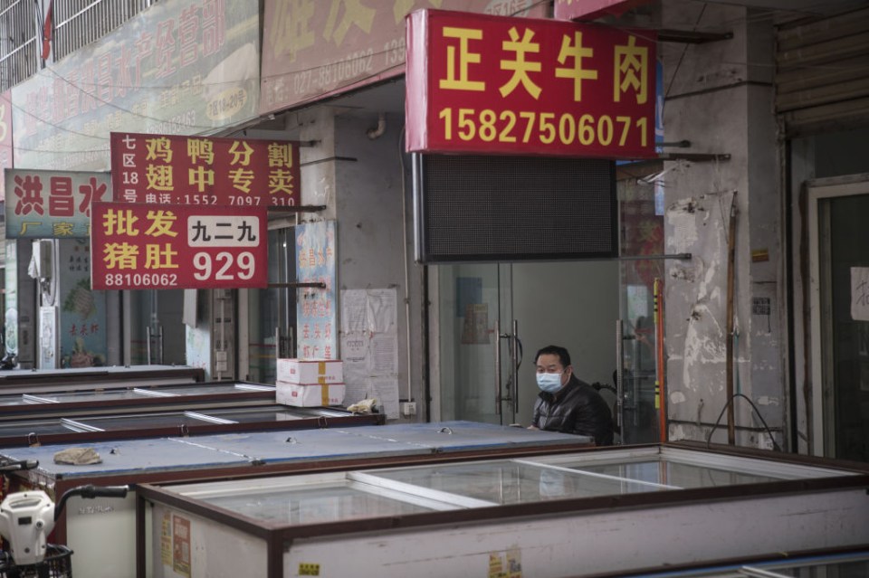 A vendor walks with a cart of goods at the Baishazhou wet market in Wuhan, Hubei Province, China