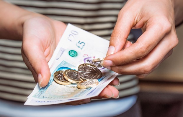 Person counting money in hands