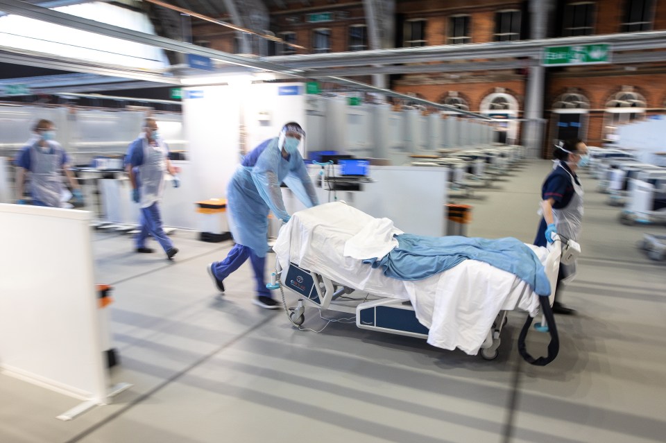  Clinicians wearing PPE role play treating a patient in cardiac arrest at the Nightingale hospital in Manchester