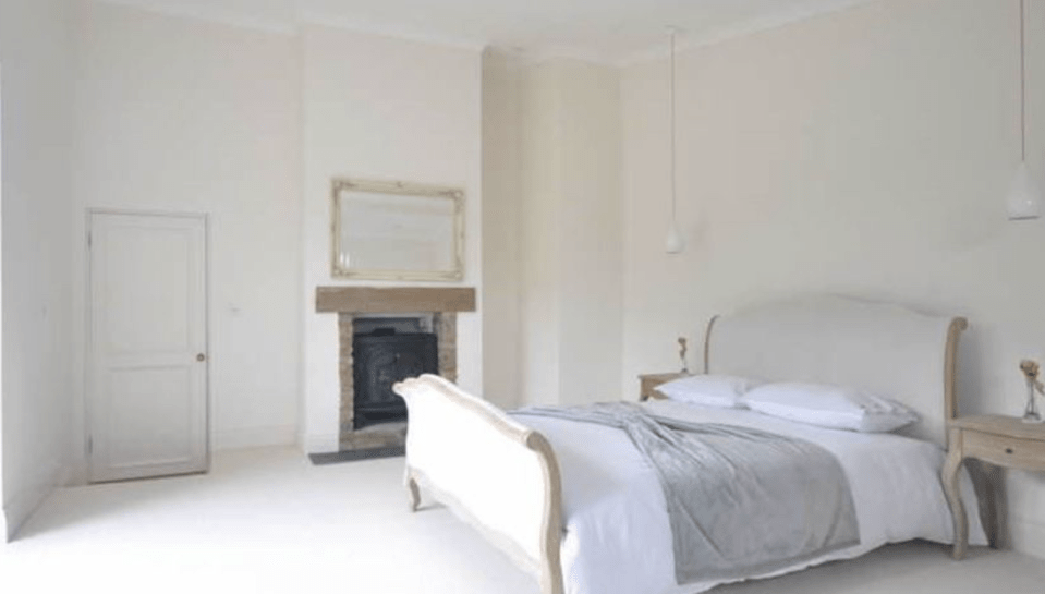  The master bedroom is decorated in chic white